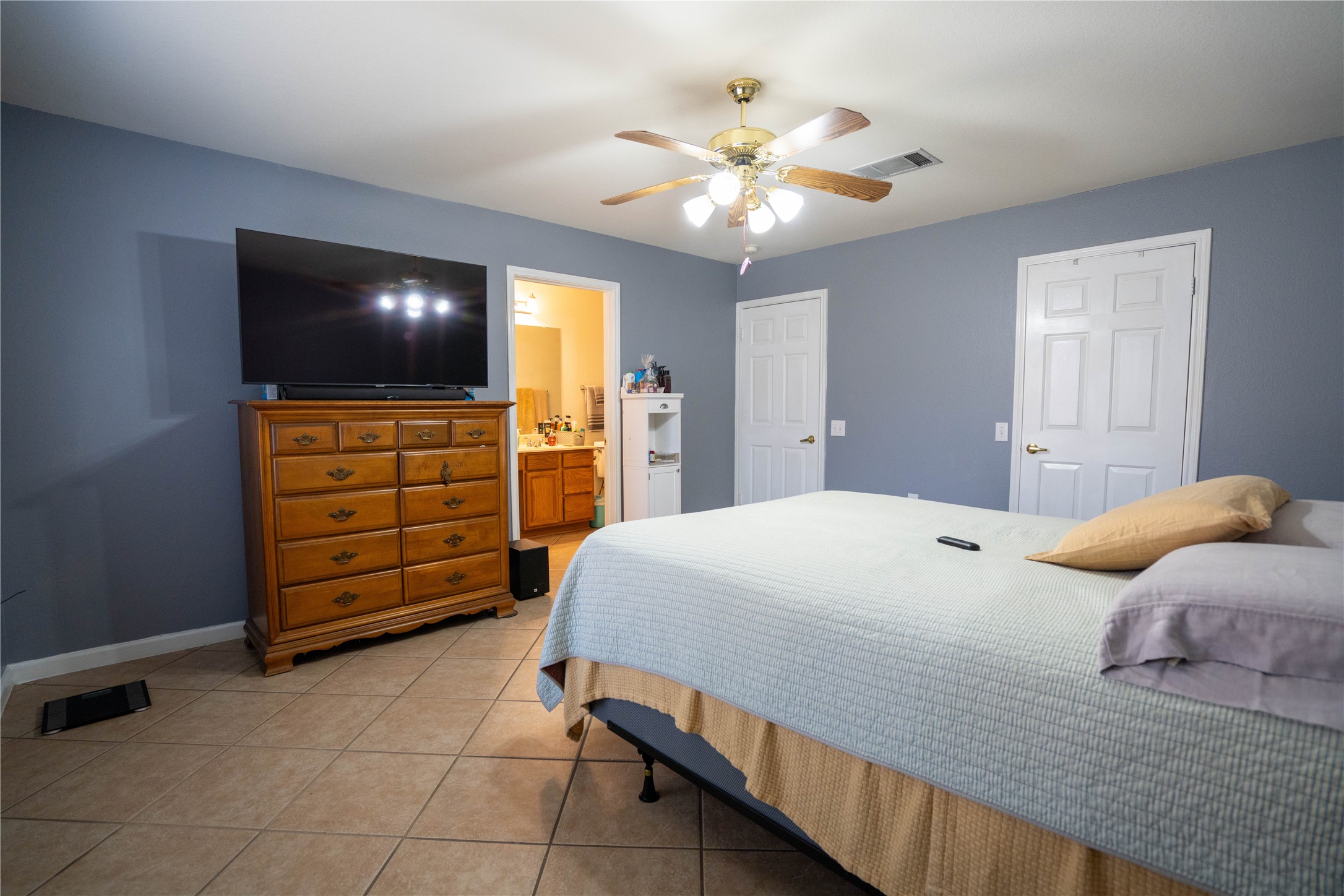 7516 Cats-Eye Lane Austin, TX 78747 - Photo 25 of 30 a bedroom with a bed and a flat screen tv