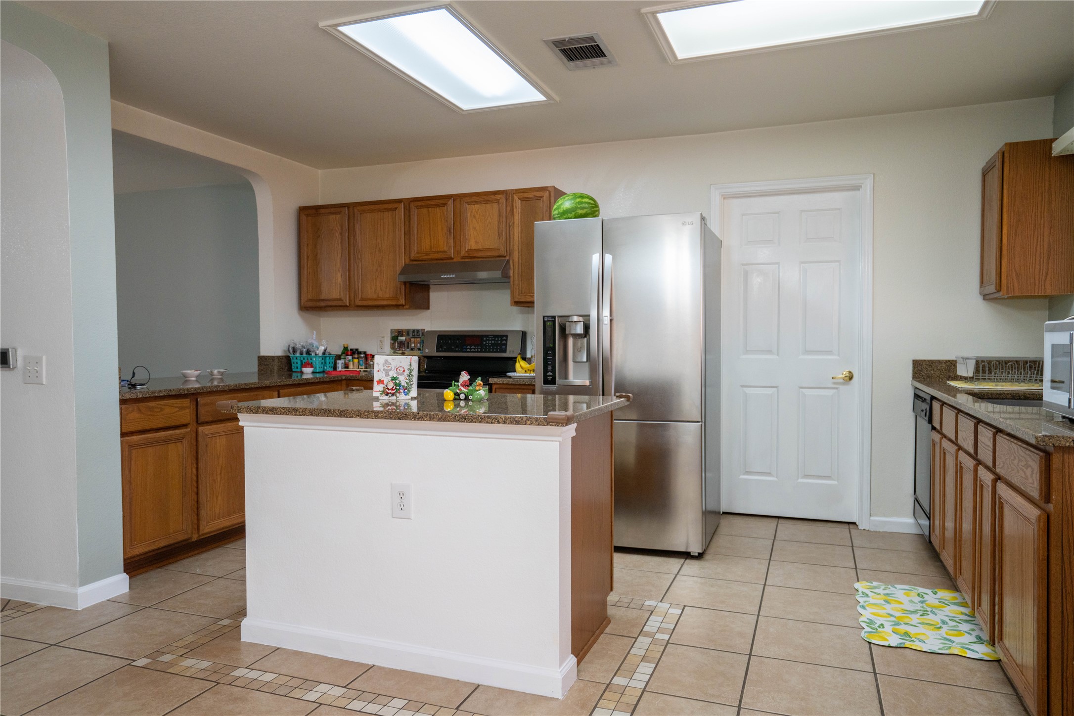 7516 Cats-Eye Lane Austin, TX 78747 - Photo 10 of 30 a kitchen with stainless steel appliances granite countertop a refrigerator a stove and a sink