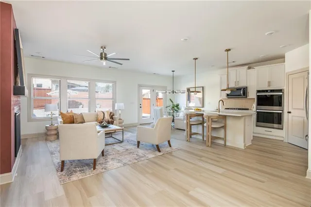 a living room with furniture and kitchen view