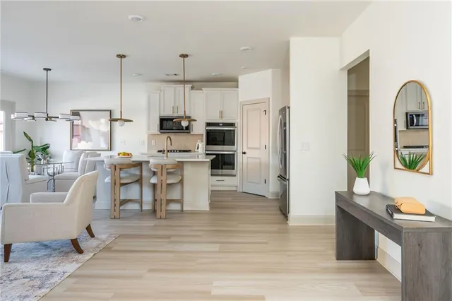a living room with stainless steel appliances kitchen island granite countertop furniture