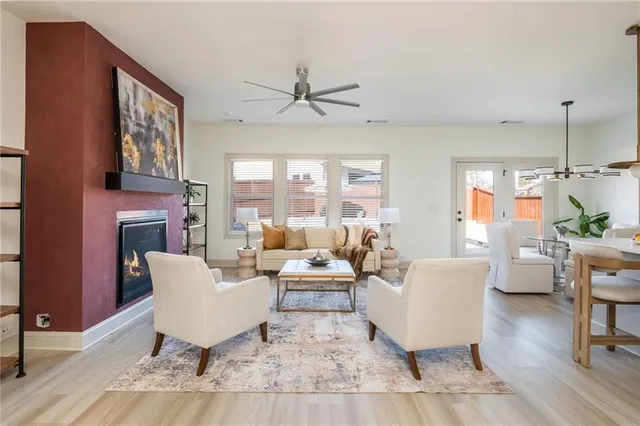a living room with furniture a fireplace and a table