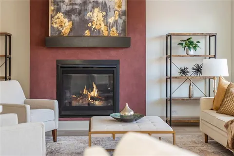 a living room with furniture a fireplace and a painting on the wall