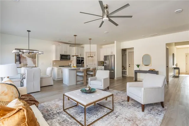 a living room with furniture and kitchen view