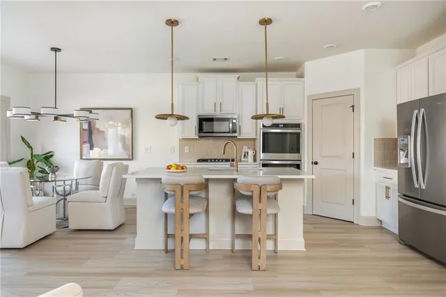 a kitchen with stainless steel appliances and white cabinets