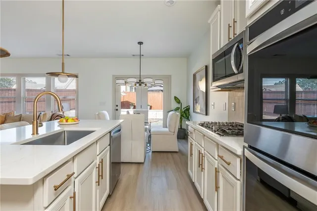 a kitchen with a sink stove and cabinets