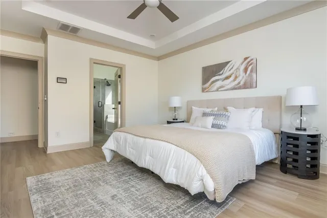 a sink with white wooden cabinets