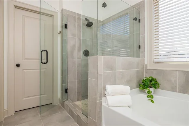 a bath tub sitting in a bathroom next to a window