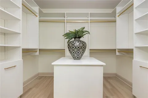 a view of a hallway with wooden floor and windows