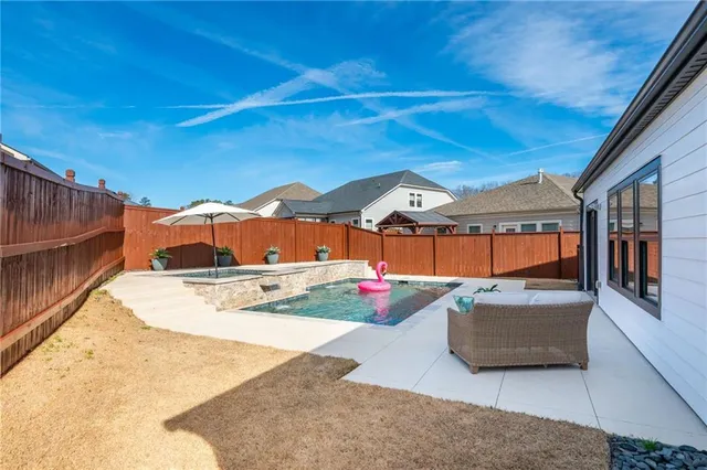 a view of swimming pool with seating area
