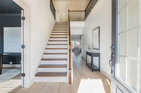 a view of entryway and hall with wooden floor