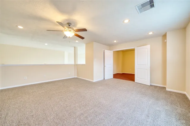 a view of a room with a ceiling fan