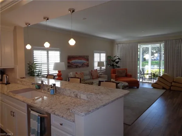 a kitchen with sink stove and living room