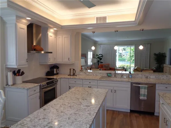a kitchen with stainless steel appliances granite countertop a stove a sink dishwasher and a refrigerator