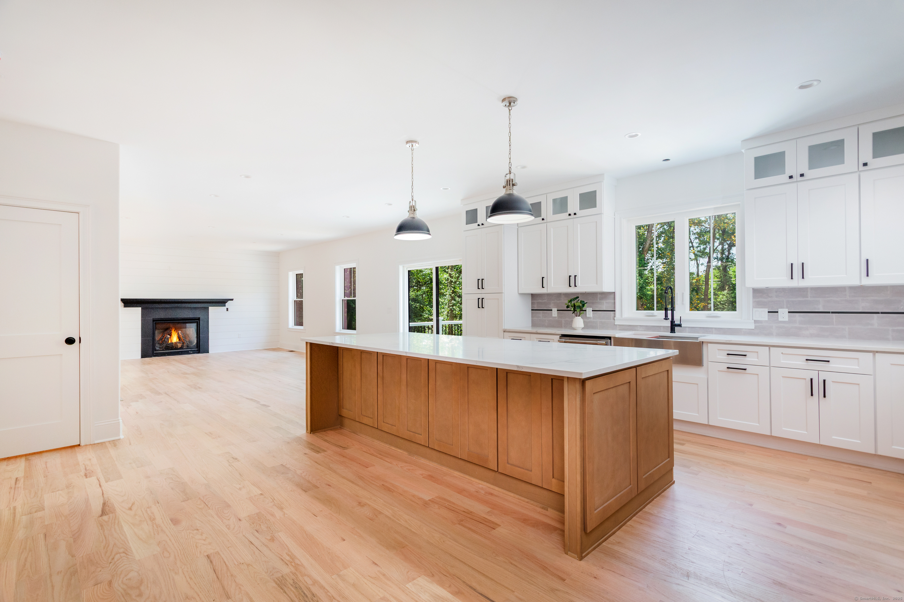815 James Farm Road Stratford, CT 06614 - Photo 11 of 34 a kitchen with stainless steel appliances granite countertop a sink a stove and a wooden floors