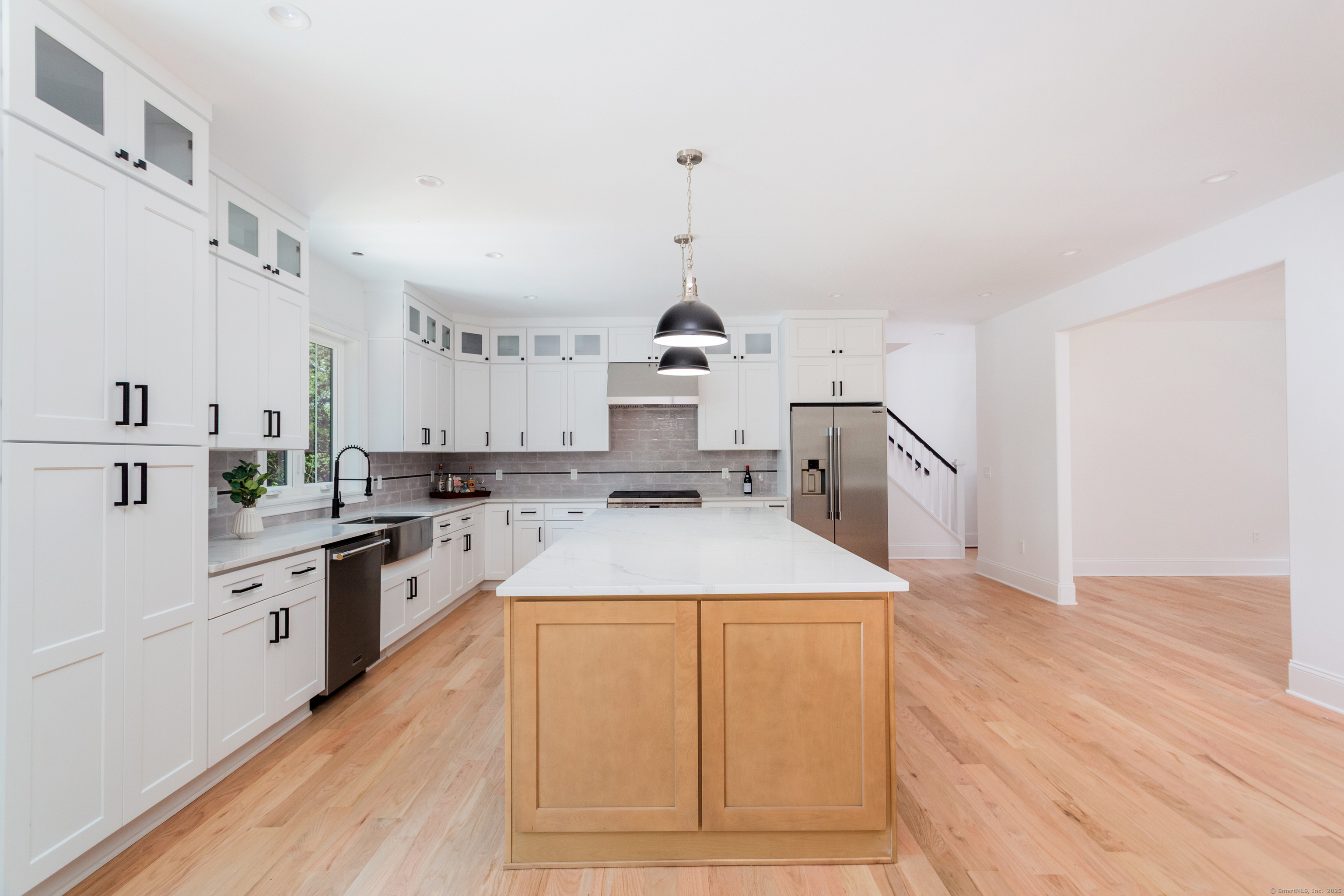 815 James Farm Road Stratford, CT 06614 - Photo 12 of 34 a kitchen with sink cabinets and wooden floor