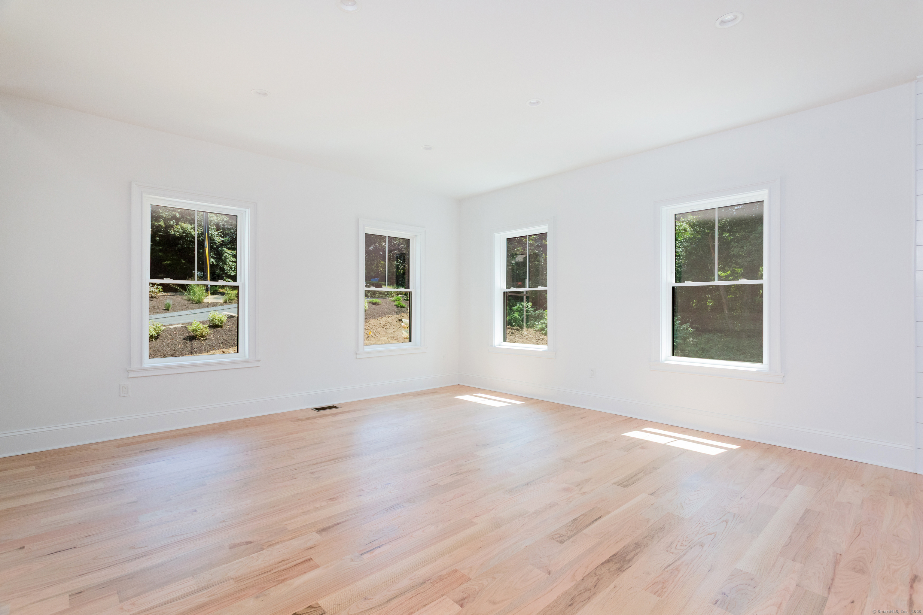 815 James Farm Road Stratford, CT 06614 - Photo 18 of 34 a view of an empty room with wooden floor and a window