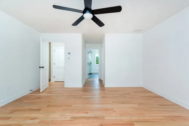 a view of an empty room and wooden floor