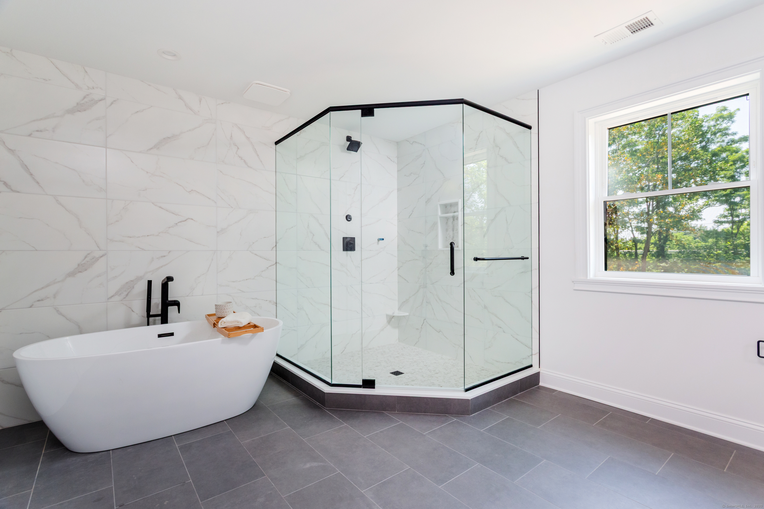 815 James Farm Road Stratford, CT 06614 - Photo 25 of 34 a bathroom with a white tub shower and window