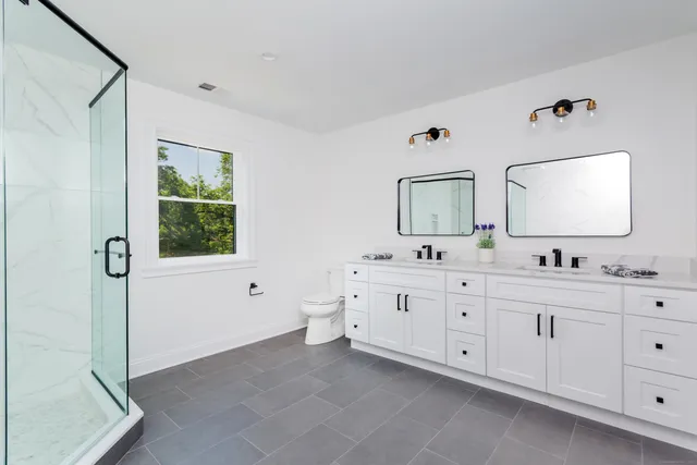 a spacious bathroom with 2 sink tub and a mirror