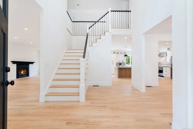 a view of entryway and hall with wooden floor