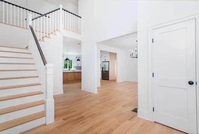 a view of entryway and hall with wooden floor