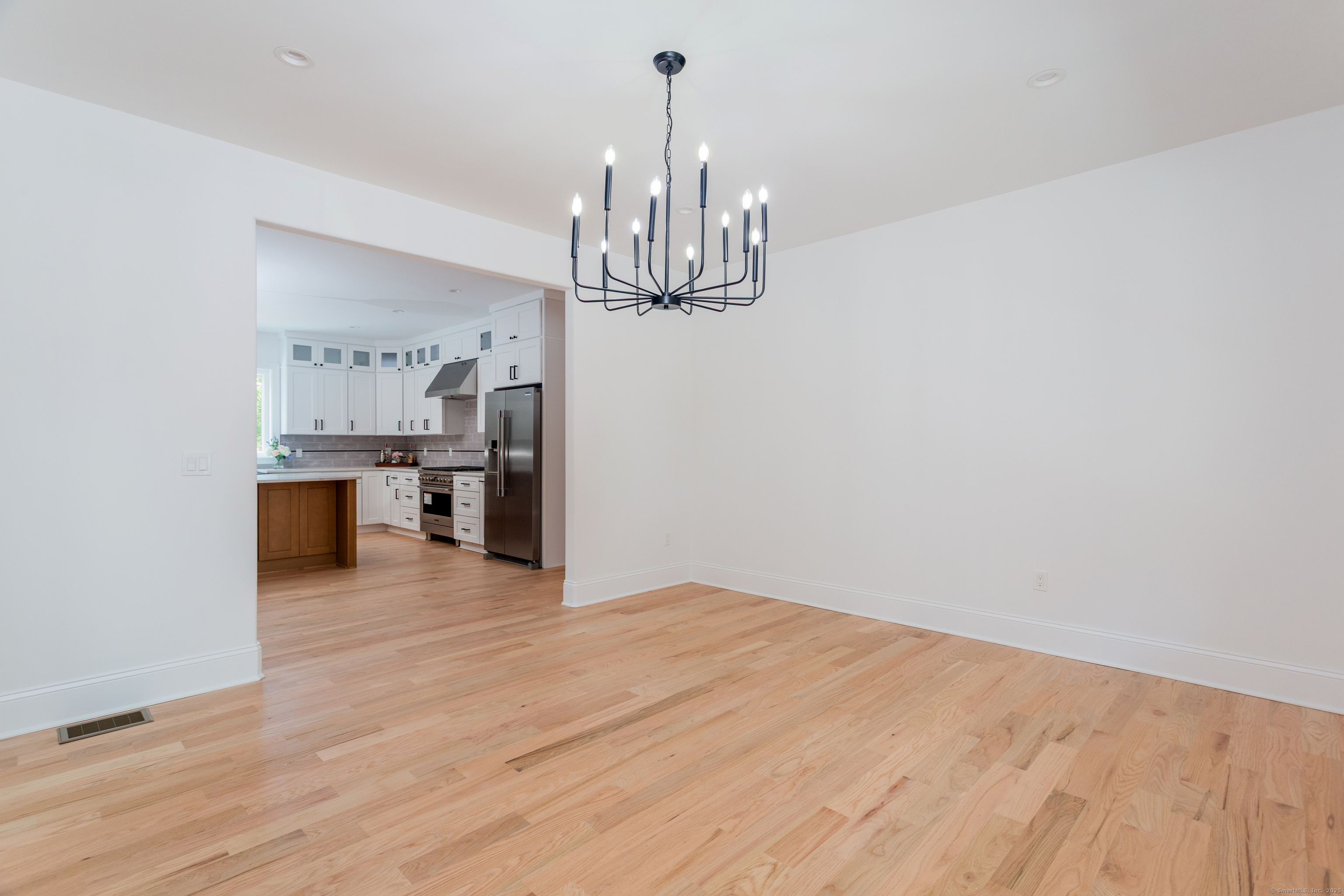 815 James Farm Road Stratford, CT 06614 - Photo 7 of 34 a view of a kitchen with a sink and dishwasher a refrigerator with wooden floor