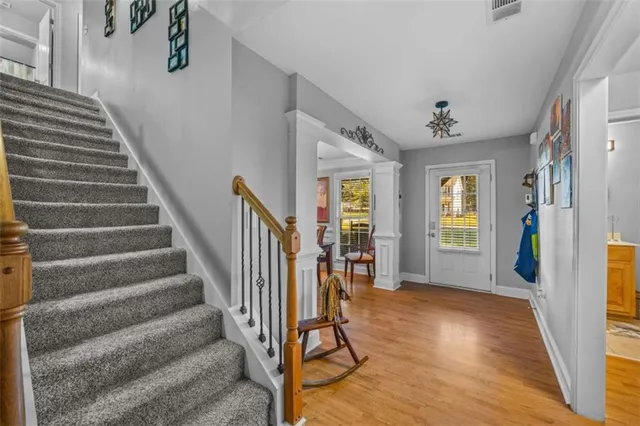 a view of entryway with wooden floor and stairs