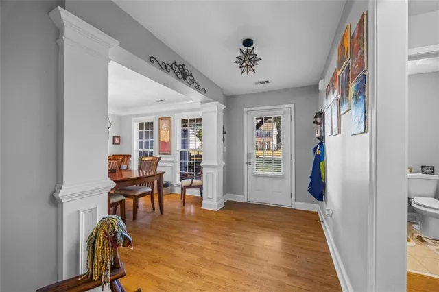 a view of a hallway with workspace and wooden floor