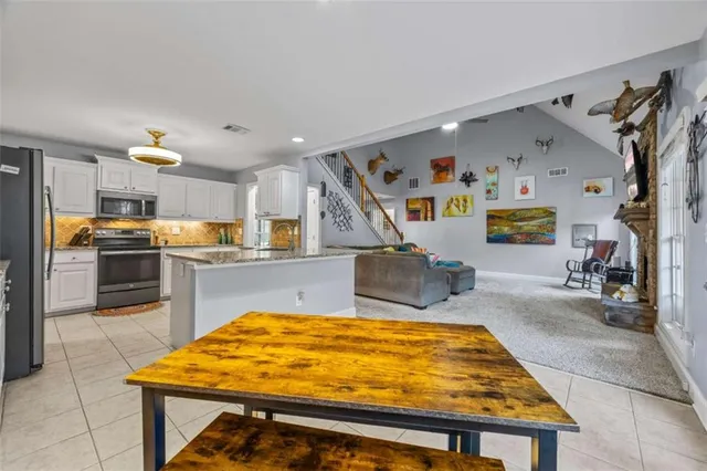 a room with wooden cabinets and dining table