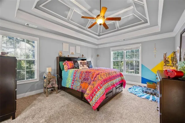 a bedroom with a bed a dresser next to a window