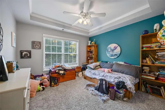 a bedroom with furniture and a large window