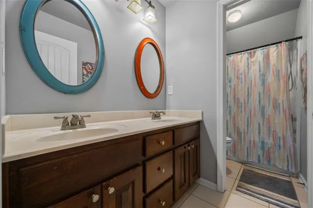 a bathroom with a double vanity sink and a mirror