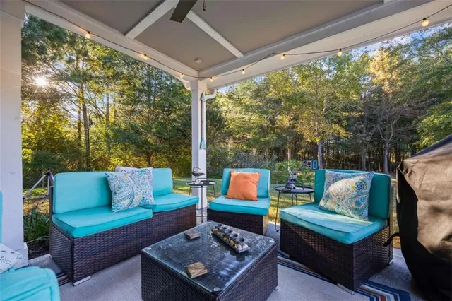 a outdoor living space with furniture and a floor to ceiling window