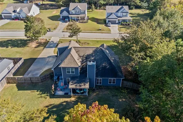 an aerial view of residential houses with yard