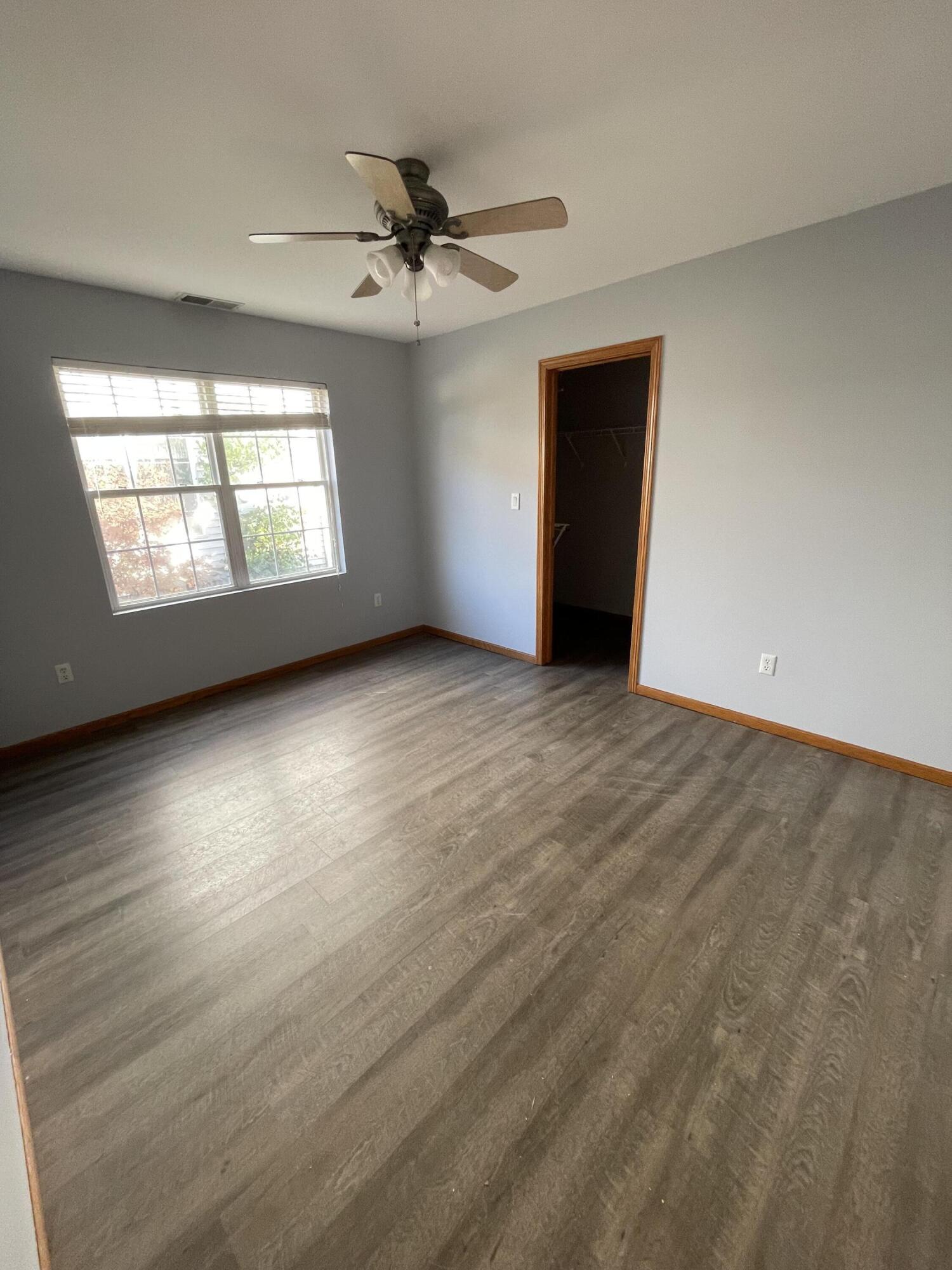 1738 Beech Drive Crown Point, IN 46307 - Photo 11 of 16 an empty room with wooden floor fan and windows