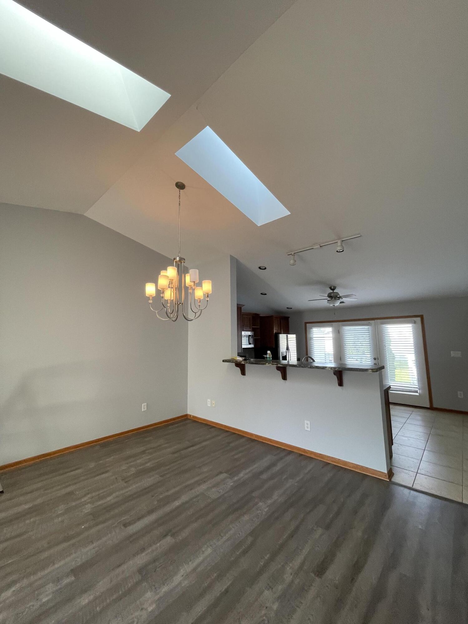 1738 Beech Drive Crown Point, IN 46307 - Photo 4 of 16 a view of a hallway with an empty room and chandelier fan