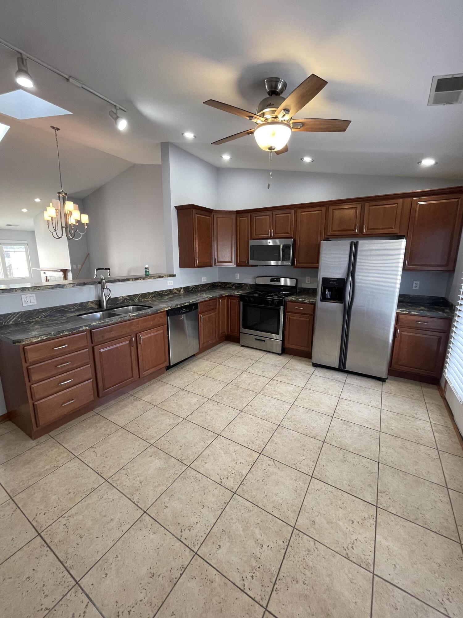 1738 Beech Drive Crown Point, IN 46307 - Photo 5 of 16 a kitchen with stainless steel appliances granite countertop a sink and cabinets