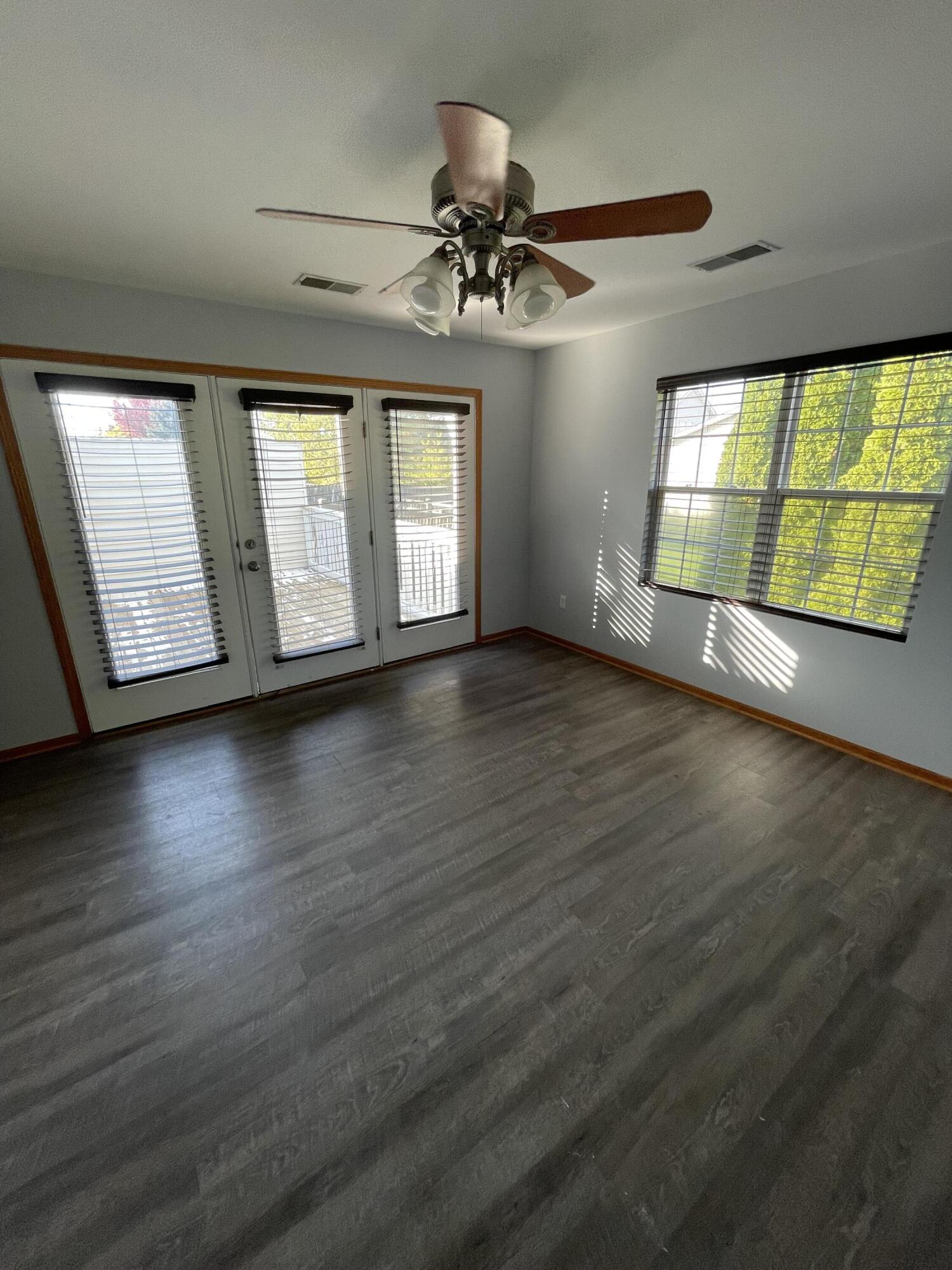 1738 Beech Drive Crown Point, IN 46307 - Photo 9 of 16 an empty room with wooden floor chandelier and windows