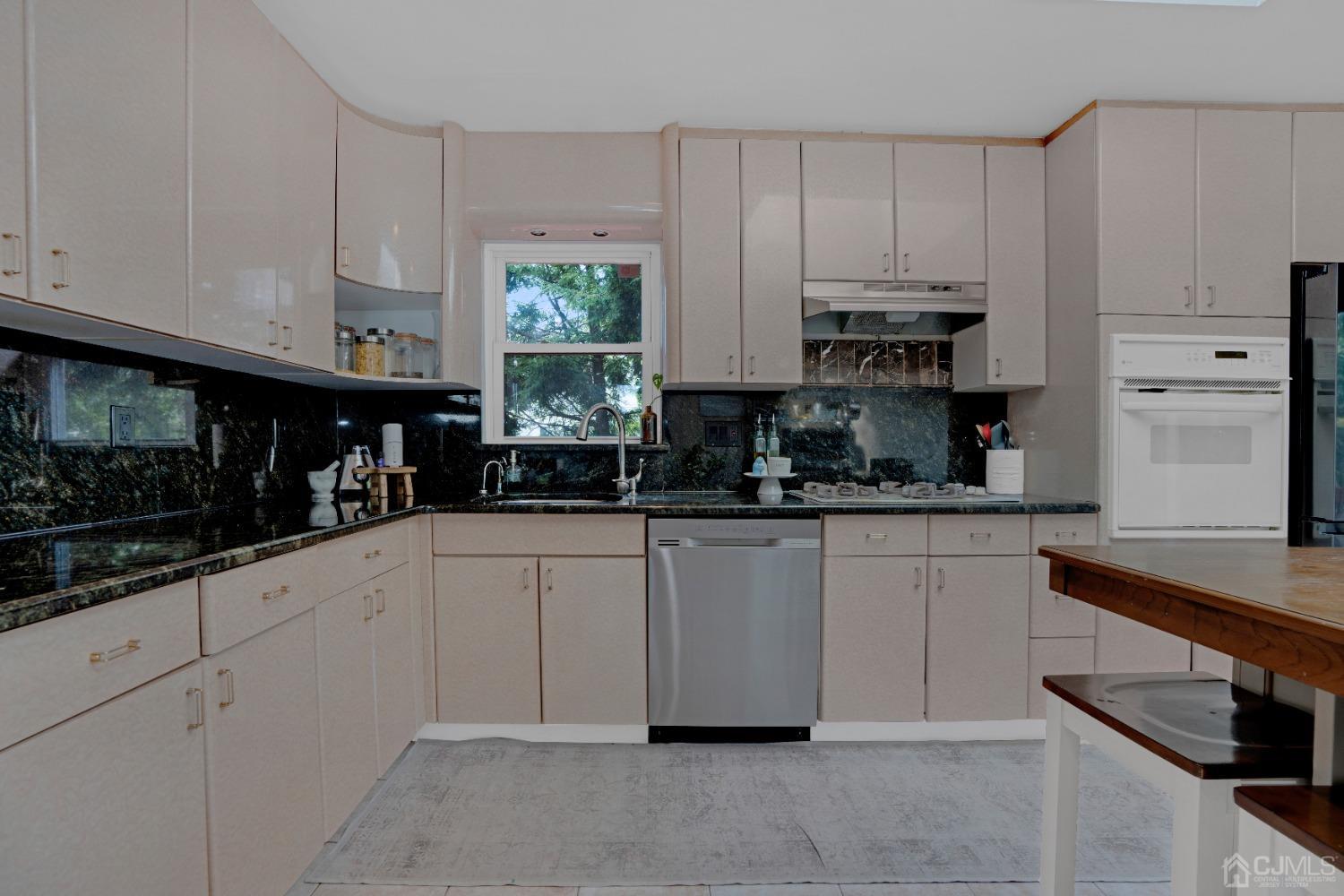 41 Laura Avenue Edison, NJ 08820 - Photo 13 of 45 a kitchen with cabinets appliances and a sink