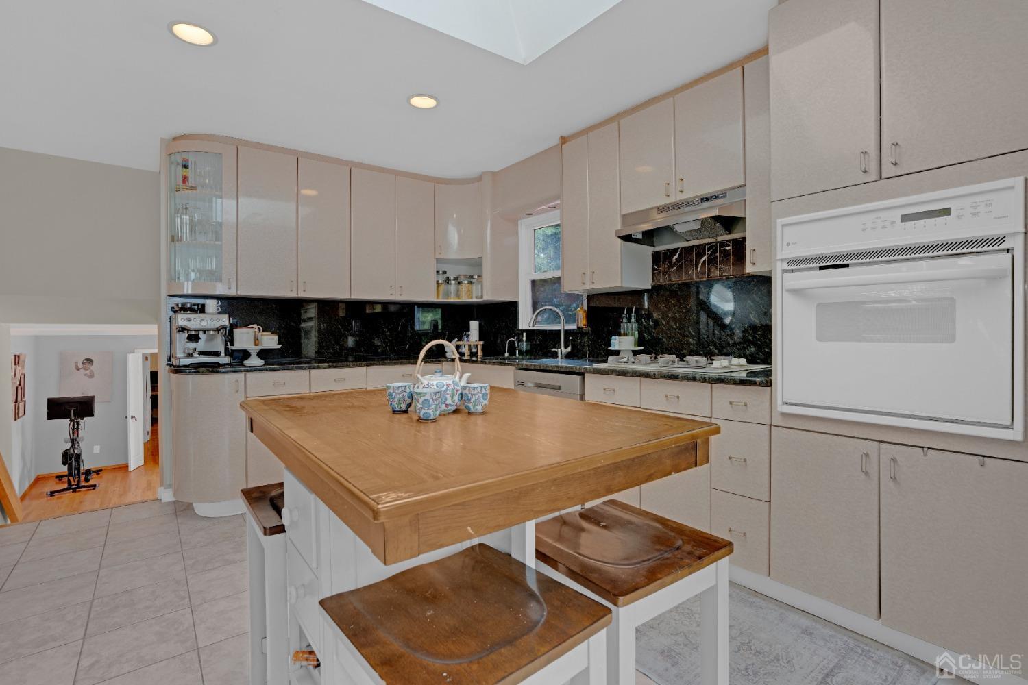 41 Laura Avenue Edison, NJ 08820 - Photo 14 of 45 a kitchen with stainless steel appliances granite countertop a sink a stove and a refrigerator