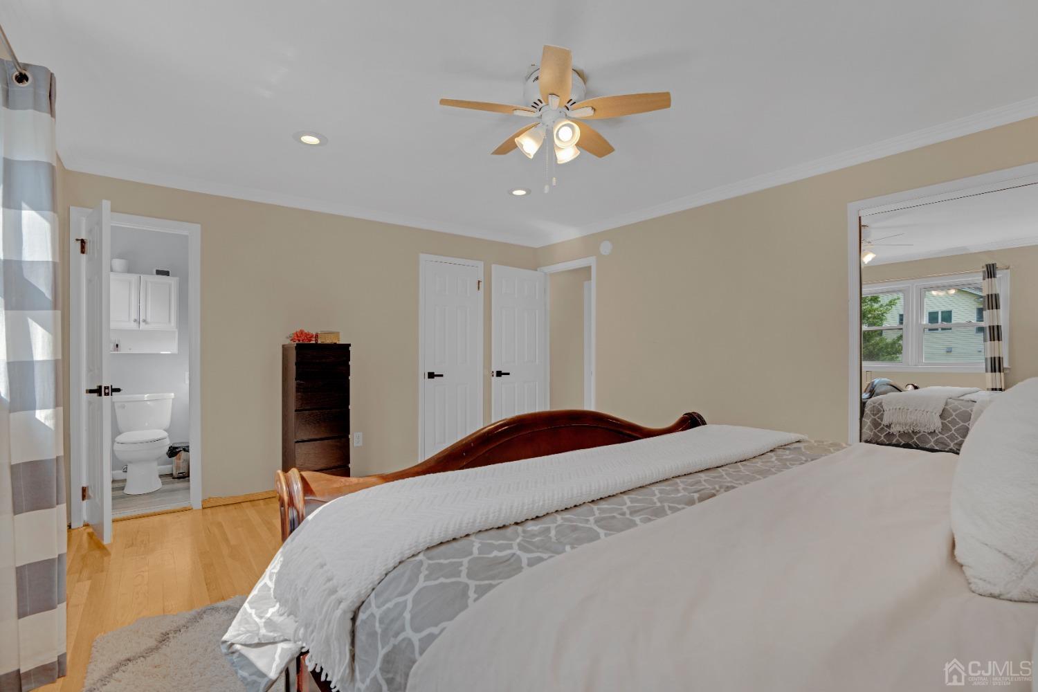 41 Laura Avenue Edison, NJ 08820 - Photo 20 of 45 a bedroom with a large bed and a chandelier