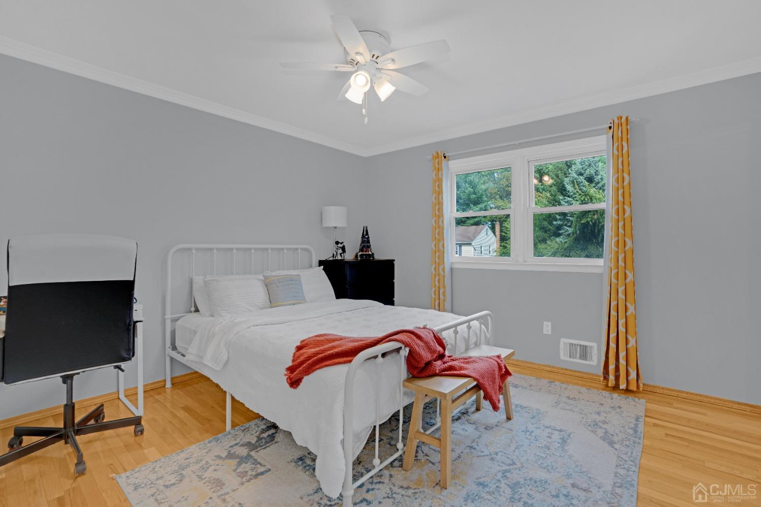 41 Laura Avenue Edison, NJ 08820 - Photo 23 of 45 a bedroom with a bed and a chandelier