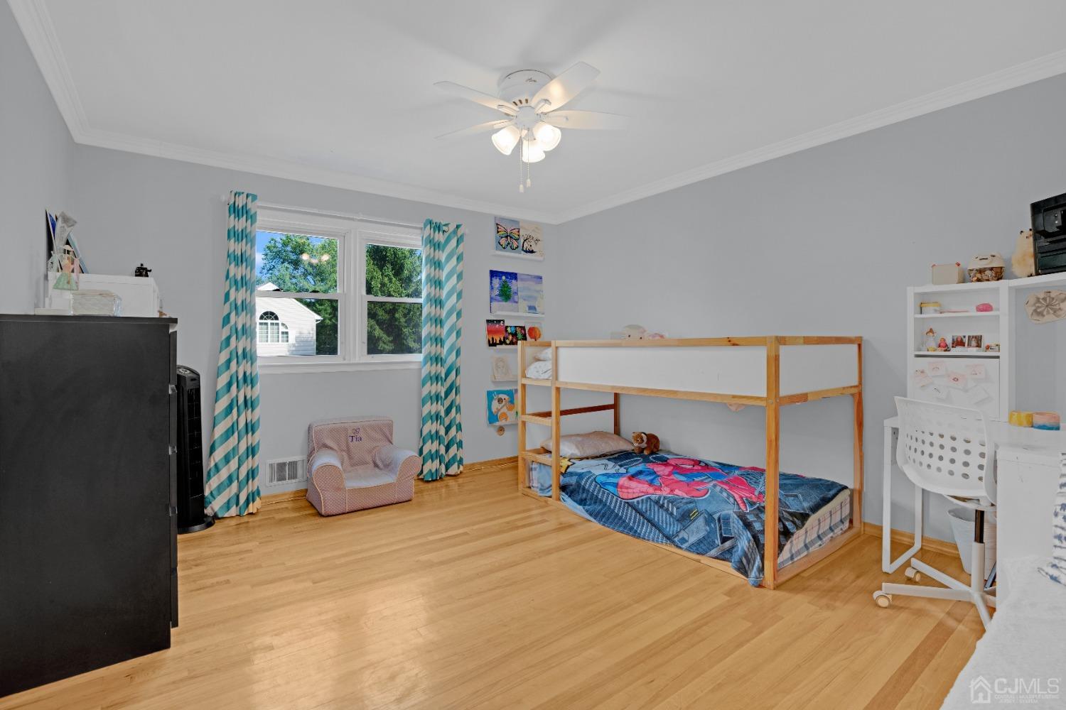 41 Laura Avenue Edison, NJ 08820 - Photo 25 of 45 a bedroom with a bed and a chandelier