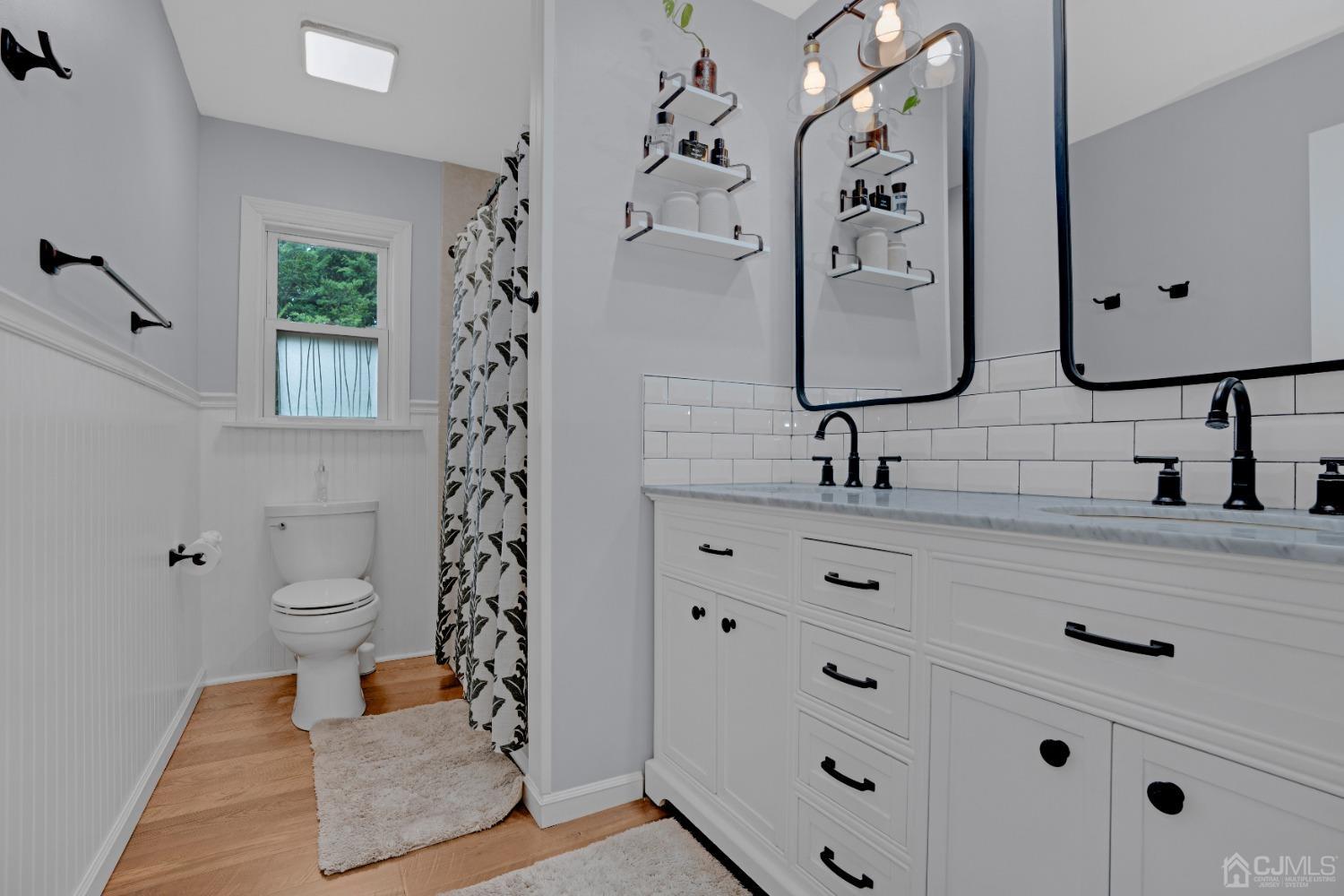 41 Laura Avenue Edison, NJ 08820 - Photo 27 of 45 a bathroom with a double vanity sink mirror and shower