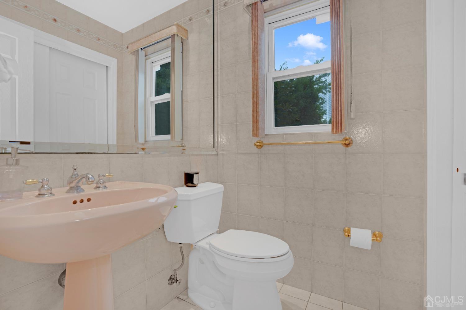 41 Laura Avenue Edison, NJ 08820 - Photo 32 of 45 a bathroom with a sink a toilet and mirror