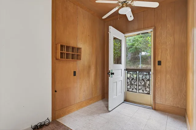 an empty room with windows and closet
