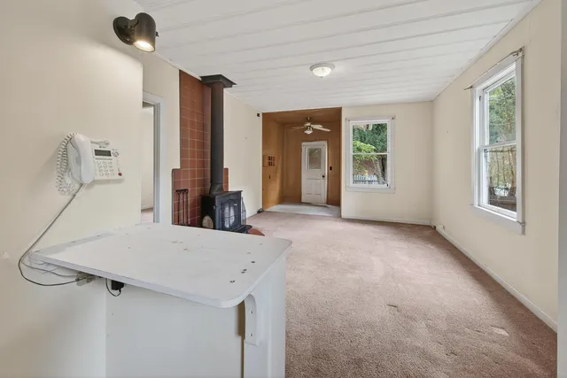 a view of a room that has a bed and a large window