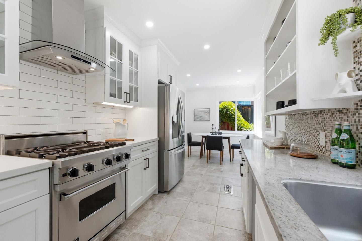 9858 Golf Links Road Oakland, CA 94605 - Photo 7 of 39 a kitchen with stainless steel appliances granite countertop a stove a sink and a microwave