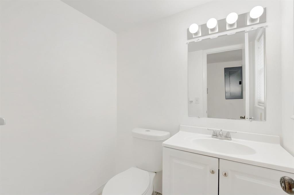 5501 Northwest 2nd Avenue, Unit 302 Boca Raton, FL 33487 - Photo 19 of 26 a bathroom with a toilet a sink and mirror