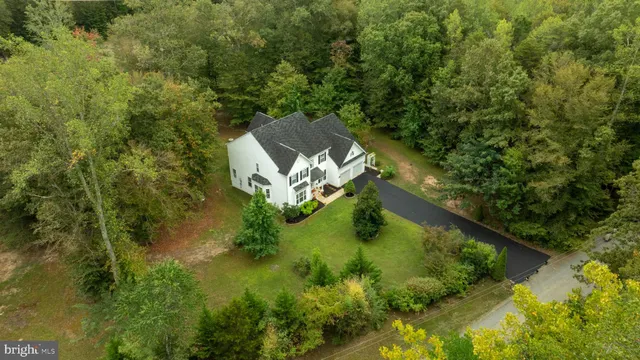 a view of a hallway view with wooden floor and staircase